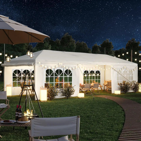 10x30 Ft Outdoor Party Tent With 8 Removable Sidewalls, Large Canopy Gazebo for Weddings, shown in a backyard at night with lights.