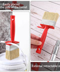 Three Piece Deck Stain And Sealer Brush Set for Wood showing red-handled brush with retractable stick on deck surface.