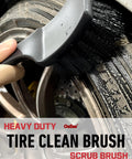 Close-up of a tire being cleaned with a heavy-duty brush from Pro Grade 4 Pack Long Handle Wheel Brush Kit For Cleaning Rims and Tires with Two Soft Wheel Brushes Detailing Brush and Stiff Tire Brush Bendable Durable Rim Cleaner Set.