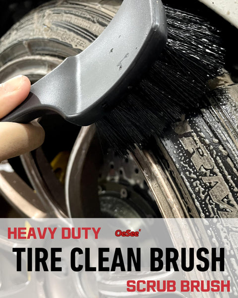 Close-up of a tire being cleaned with a heavy-duty brush from Pro Grade 4 Pack Long Handle Wheel Brush Kit For Cleaning Rims and Tires with Two Soft Wheel Brushes Detailing Brush and Stiff Tire Brush Bendable Durable Rim Cleaner Set.