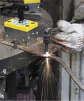 Heavy Duty Magnetic Welding Square Base Clamp Holder With Rock Solid 1050 Lbs Grip And Easy Toggle Switch For Steel Fabrication Or Woodworking Gear in use during welding with sparks flying.