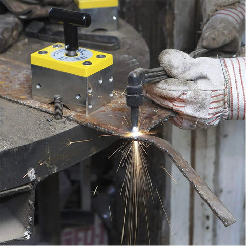 Heavy Duty Magnetic Welding Square Base Clamp Holder With Rock Solid 1050 Lbs Grip And Easy Toggle Switch For Steel Fabrication Or Woodworking Gear in use during welding with sparks flying.