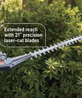 Gas Hedge Trimmer With 21-Inch Cutter Bar, Double-Sided Reciprocating Blades trimming green hedge outdoors.