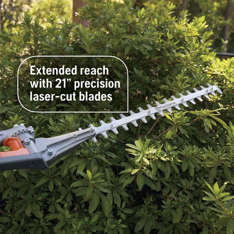 Gas Hedge Trimmer With 21-Inch Cutter Bar, Double-Sided Reciprocating Blades trimming green hedge outdoors.