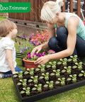 Woman and child using Seed Starter Kit With 10 1020 Seed Trays And 2 Seedling Heat Mats For Faster Germination In Indoor Gardens And Greenhouses