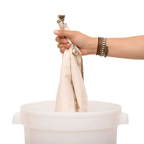 Person holding Industrial 10 Gallon Reusable Coffee Filter Set With Organic Cotton GOTS Certified Two Pack for Large Urns over bucket