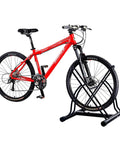 Red mountain bike in Mighty Rack Two Bike Floor Stand For Easy Clamp-Free Bicycle Parking, Heavy Duty Tubular Steel Construction Lets You Roll In Two Bikes At Once And Walk Away, Versatile Indoor Bike Park Solution For Garage Or Home.