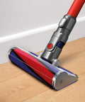 Soft Roller Cleaner Head for V7 Vacuum Cleaners Plush Fluffy Roller Attachment cleaning wooden floor next to white wall