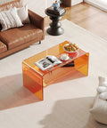 Orange Acrylic Coffee Table With Open Storage Two Tier Clear Modern Coffee Table For Living Room Office Reception And Bedroom Transparent Side Table With A Dope See Through Look And Durable Build in a living room setting with decor items.