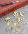Heavy Duty 4 Pack Brass D Rings For Purse Hardware With Ball End Studs And Installation Tools Light Gold Finish on stone surface.