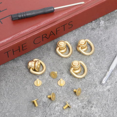 Heavy Duty 4 Pack Brass D Rings For Purse Hardware With Ball End Studs And Installation Tools Light Gold Finish on stone surface.