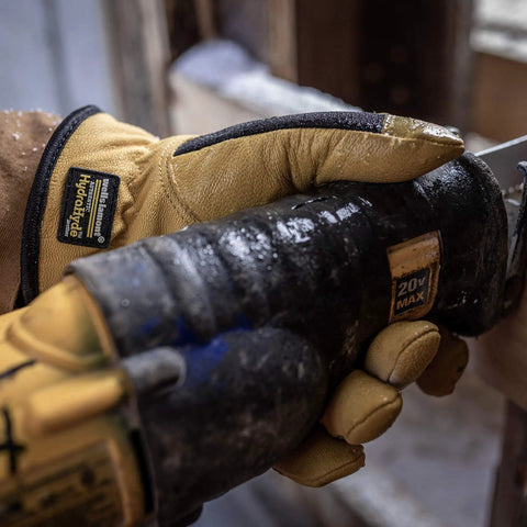 Men's Insulated Water-Resistant Leather Palm Winter Work Gloves With Goat Skin Palm gripping a power tool.