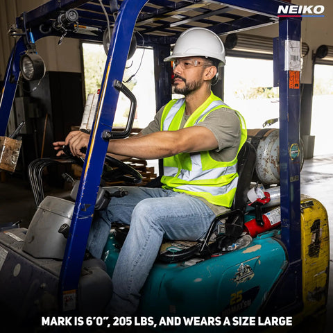Man operating a forklift wearing a Neon Yellow High Visibility Safety Vest ANSI Class 2 with two pockets, size large.