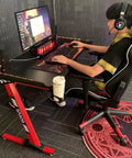 Dope Rose Pink Gaming Desk With Rgb Ambient Glow Spacious Pc Worktable For Home Office And Bedroom Setup Height Adjustable Standing Table For Teens And Students in use with monitor and gaming chair.