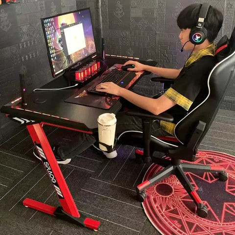 Dope Rose Pink Gaming Desk With Rgb Ambient Glow Spacious Pc Worktable For Home Office And Bedroom Setup Height Adjustable Standing Table For Teens And Students in use with monitor and gaming chair.