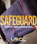 Two people carrying furniture wrapped in Heavy Duty Moving Blankets 72x80 4 Pack Blue Polyester Quilted Furniture Pads for protection.