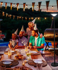Solar Powered Outdoor Floor Lamp for Patio and Garden in family gathering scene, with party hats and dinner setup