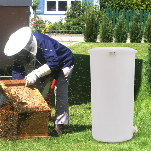 Two-Frame Manual Honey Extractor for Beekeeping, Durable Plastic Centrifuge Tool, White, Easy Grip S-Shaped Handle, Ideal for Home or Store Honey Harvesting, 15.75 by 28.35 Inches beside beekeeper inspecting hive