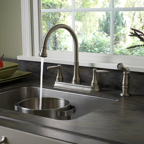 Glenfield 2-Handle High Arc Kitchen Faucet With Side Sprayer In Stainless Steel ADA Compliant Ceramic Disc Valve Tech Tri-Flow Water Control Built To Last No-Fuss Cleaning, mounted on a kitchen sink.