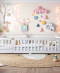 Totally Built Tough Twin Floor Bed With Montessori Design And Complete Safety Guardrails Plus Easy Access Door For Kids, Solid Wood Low Profile Slatted Frame In Fresh White in a decorated nursery.