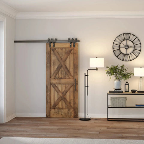 Height Adjustable Floor Lamp With Elongated Fabric Shade In Brushed Nickel Finish beside a barn door in a modern living room.