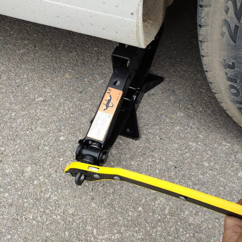 360 Degree Swivel Head Jack Ratchet Wrench With Forward And Reverse Knob in use with scissor jack under car