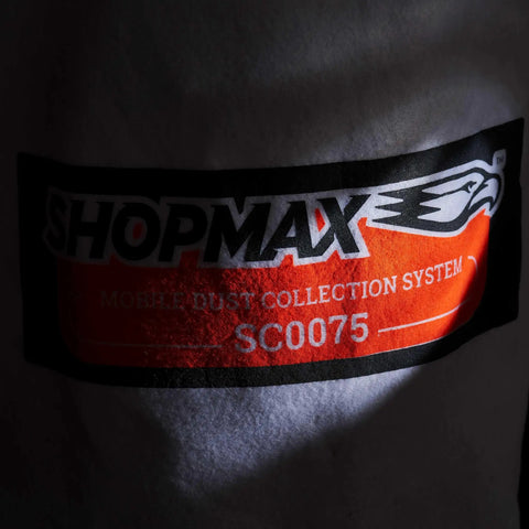 Close-up of Shopmax mobile dust collection system label on fabric, featuring model SC0075.