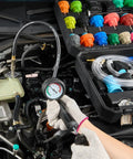 Heavy Duty 28 Piece Universal Radiator Pressure Tester Kit With No Sweat Manual Coolant Refill and adapter caps in car engine.