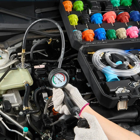 Heavy Duty 28 Piece Universal Radiator Pressure Tester Kit With No Sweat Manual Coolant Refill and adapter caps in car engine.