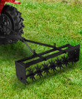Tow Behind Lawn Aerator 32 Inch Heavy Duty Core Aerator Tool with universal hitch attached to tractor on grass