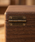 Close-up of 12 Piece Mini Antique Cabinet Hinges 1.4 Inch Round Corner Iron Foldable Hinges on a wooden jewelry box.