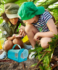 Two Piece Bug Catcher Kit For Kids with children observing bugs outdoors using magnifying glass and cages in nature setting.