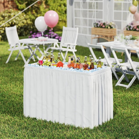 Portable Folding Ice Cooler Table With Drain And Satin Skirt Matching Foldable Bucket Bev Station in garden party setting