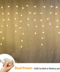 Fairy Curtain Lights USB Powered And Battery Operated 13ft 96 LED Globe Icicle String glowing in warm white ambience on wall