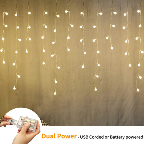 Fairy Curtain Lights USB Powered And Battery Operated 13ft 96 LED Globe Icicle String glowing in warm white ambience on wall