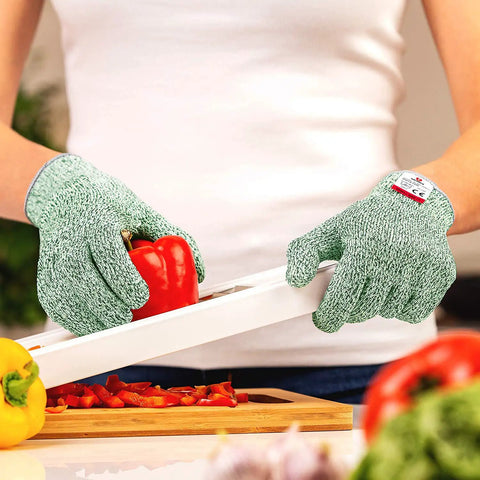 Person using Cut Resistant Gloves Pro Grade Level 5 For Food Prep Ambidextrous And Machine Washable Ultra Comfortable to slice red pepper.