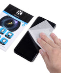CAMKIX lens cleaning tissue paper booklets with a double-sided cleaning cloth used on a smartphone screen, front view