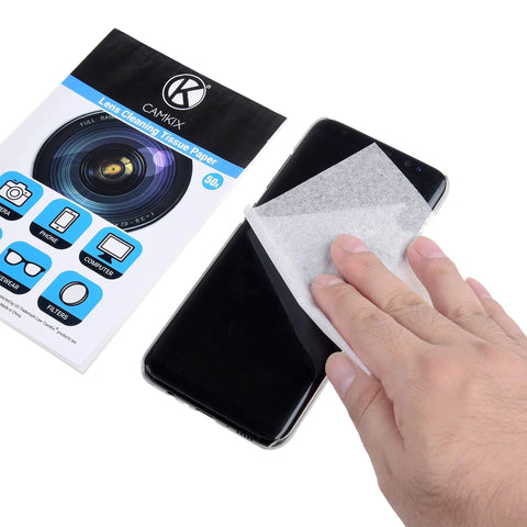 CAMKIX lens cleaning tissue paper booklets with a double-sided cleaning cloth used on a smartphone screen, front view