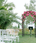 88 Inch Steel Garden Arch Arbor Trellis For Climbing Plants Outdoor Yard Garden Black Metal Lattice Arch Perfect For Weddings Backdrops And Patio Decor Go To Yard Art amid chairs and lush greenery