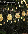 Battery Operated 25 Feet 100 LED Warm White Hanging String Lights With 20 Bulbs Remote Dimmable Eight Modes Memory Timer Waterproof And Shatterproof For Indoor Outdoor Decor Perfect For Bedroom Patio Balcony Home And Christmas Party shown glowing in rain
