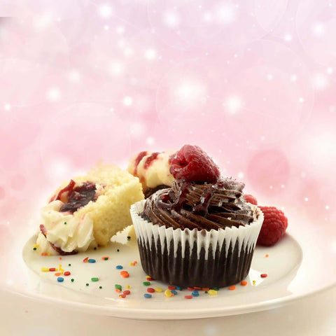 Chocolate cupcake with raspberry topping on a plate with sprinkles, showcasing decorating potential of Cupcake Injector And Decorating Icing Kit.