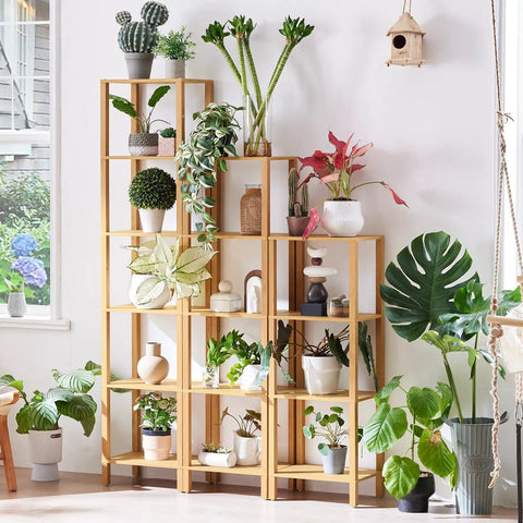 Five Tier Tall Narrow Bookshelf Takes Up Zero Floor Space While Holding All Your Favorites In A Smooth Natural Finish, displaying plants.