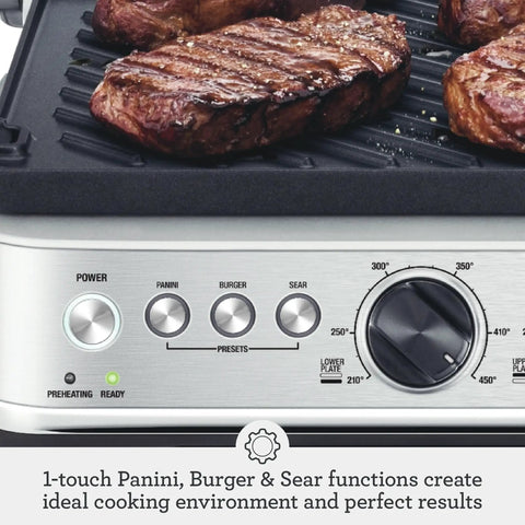 Breville Stainless Steel Electric Grill Panini Maker With One Touch Presets for burgers, cooking steaks on ceramic plates.