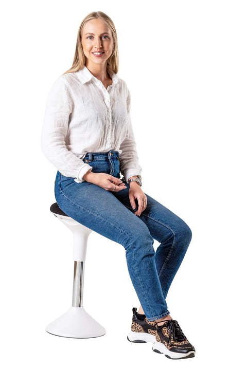 Woman sitting on Ergonomic Height Adjustable Balance Stool For Work And Home Office Wobble Chair For Sit Stand Desks in white.