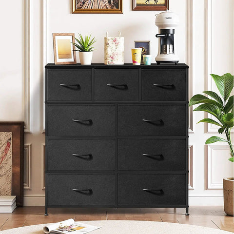 Roomy 9 Drawer Dresser With Wooden Top And Metal Frame Dope Anti Tip Tall Storage Chest For Bedroom Closet Living Room Hallway And Entryway Black Fabric Bin Organizer Sturdy Space Saving Design With Anti Tip Safety For Peace Of Mind displayed in a living room with decor on top.
