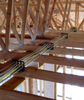Box Of Fifty H2 Homer Helpers For Electrical Wire Management holding organized wires against wooden beams during construction.