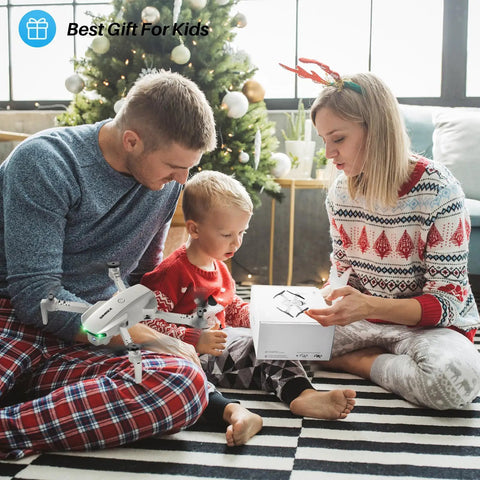 Family opening Foldable Camera Drone For Kids And Adults With Altitude Hold And Optical Flow Positioning under Christmas tree.