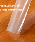 Heavy-Duty Double-Sided Carpet Tape That Stays Put 2 Inch Wide 40 Yard Rug Tape being lifted from wood floor without residue