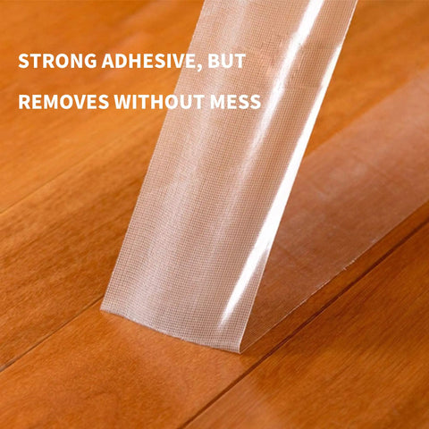 Heavy-Duty Double-Sided Carpet Tape That Stays Put 2 Inch Wide 40 Yard Rug Tape being lifted from wood floor without residue