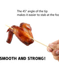 Hand holding 200 Pack Bamboo Skewers 12 Inch Wooden Kabob Sticks for Appetizers and Grilling with chicken wing